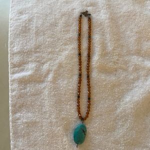 Beaded necklace with turquoise stone.